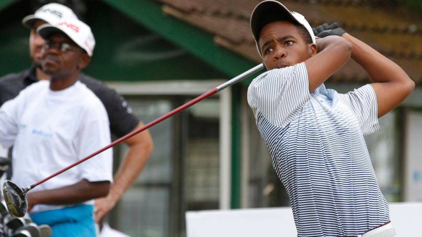 Proffesional golfer, youngster Mathew Wahome follows his tee shot at a past event
