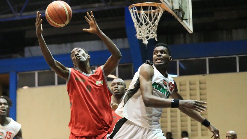Ninziza Alvin wins the ball against Mike Makiadi of Kenya Morans during their FIBA AfroBasket 2021 Qualifiers match at Nyayo