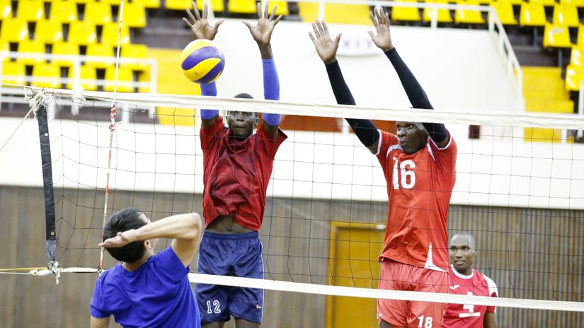 Kelvin Omuse L) Michael Chemos blocks a shot from FIVB coach Katagira Shota during their training at Kasarani Indoor Arena on May 14, 2019 ahead of the All African Games qualifiers in Uganda