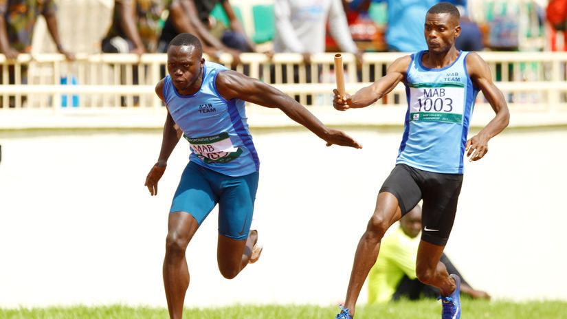 Mike Mokamba of Moi Air Base receives a button during the 400m by 4 men heat semi final during the Kenya Defence Forces Athletics Championships at Nyayo National Stadium on May 18, 2021