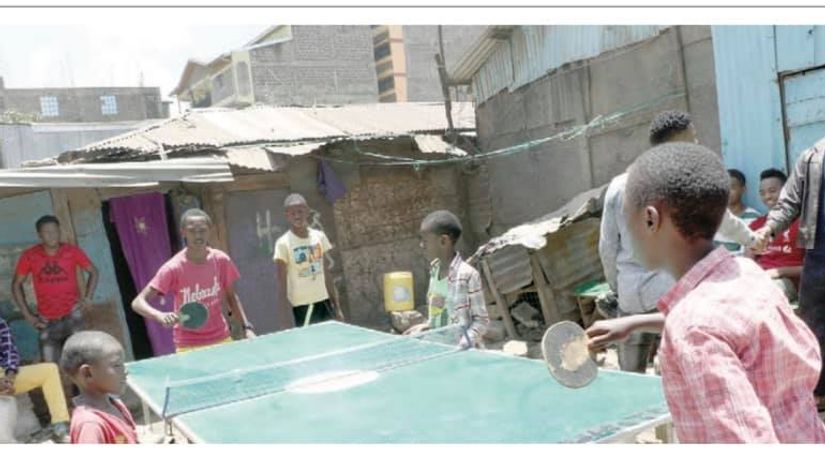 Children in Mathare Valley play table tennis © Kenna Claude