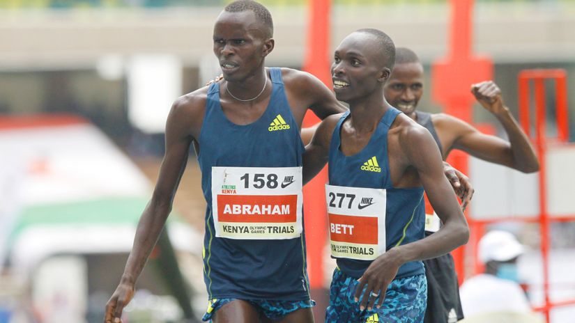 Abraham Kibiwott (L) and Leonard Bett embrace as Benjamin Kigen celebrates a third-place finish at the men 3000m SC during the Day 3 of 2020 Tokyo Olympic trials at the MISC, Kasarani on June 19, 2021