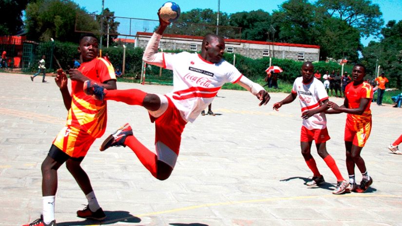 Martin Juma of Makueni Bees (Mbooni Boys High School) in full flight tries to score past Durel Okinyi of Strathmore University during a past Kenya Handball Federation League match at Kaloleni grounds. Photo/PD/PHILIP KAMAKYA