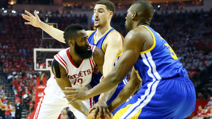 Thompson and Ezeli stopping Harden (©Ronald Martinez/Getty Images)