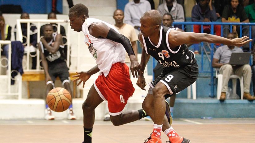 Kisumu Lakeside Dennis Wekesa (L) dribbles past Ulinzi warriors Hussein Yoyoh during the Kenya Basketball Federation Premier League play-offs at the Nyayo GYM in Nairobi on November 3, 2019.