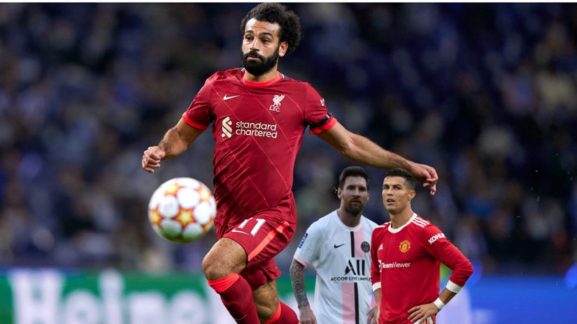 Mohamed Salah in action with Messi and Ronaldo below him (©Jose Manuel Alvarez/Quality Sport Images/Getty Images- Mozzart Sport Kenya)