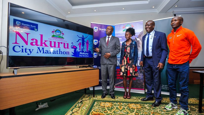 Nakuru Governor Lee Kinyanjui (left) Stanbic Bank Kenya Chief Executive (CE), Charles Mudiwa (second right) joined by World Marathon record holder and Stanbic Bank Brand Ambassador, Brigid Kosgei (center) and World Marathon and Boston Marathon champion, Geoffrey Kipkorir Kirui in unveiling the Nakuru City Marathon © Courtesy