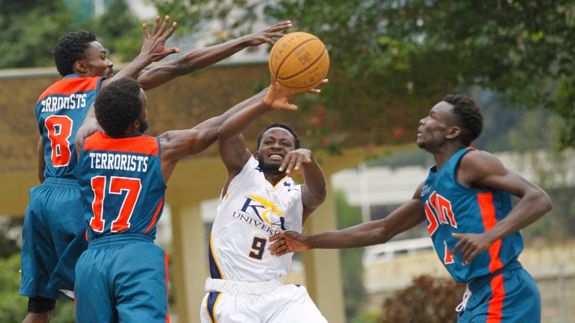 Victor Otieno of KCA is challenged by UoN markers during a KBF league match
