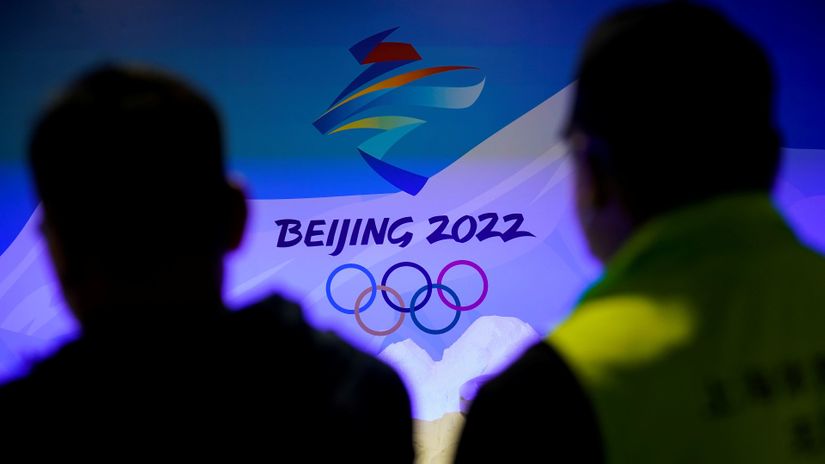 Staff members work near the emblem for Beijing 2022 Winter Olympics displayed at the Shanghai Sports Museum in Shanghai (©REUTERS/Aly Song)