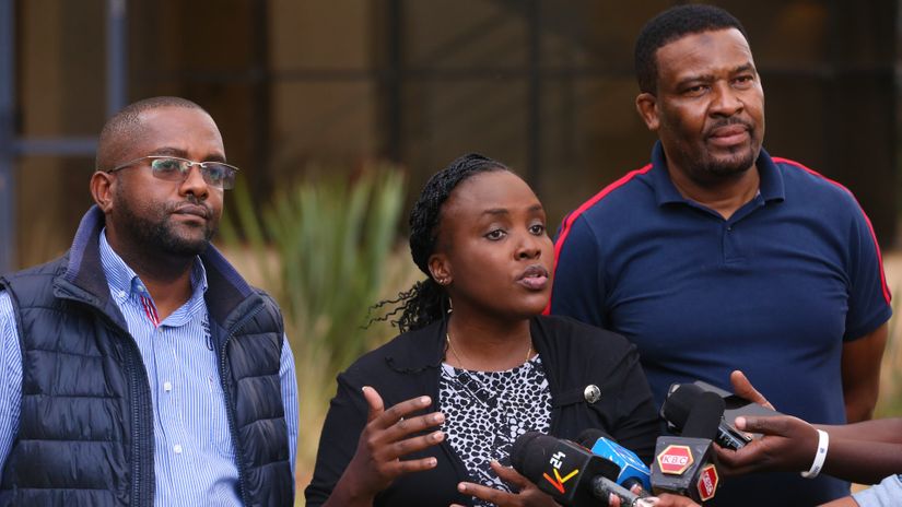 FKF Caretaker Committee head of secretariat Lindah Oguttu (C) is flanked by committee members Michael Muchemi (R) and Ali Amour during their presser at Kenya National Library service head office on November 20, 2021 © Mozzart Sport