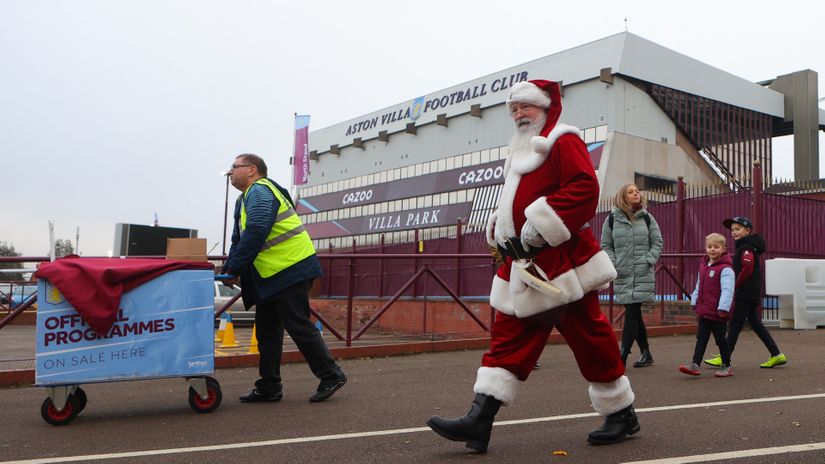 A programme seller and a man dressed as Santa Claus are seen outside Villa Park prior to the postponed Premier League match between Aston Villa and Burnley at Villa Park on December 18 (©James Gill - Danehouse/Getty Images)