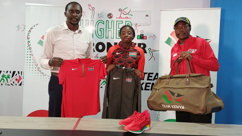Humprey Kayange (right) presents Angella Okutoyi (middle) and her coach Francis Rogoi (left) with Team Kenya merchandise © NOCK
