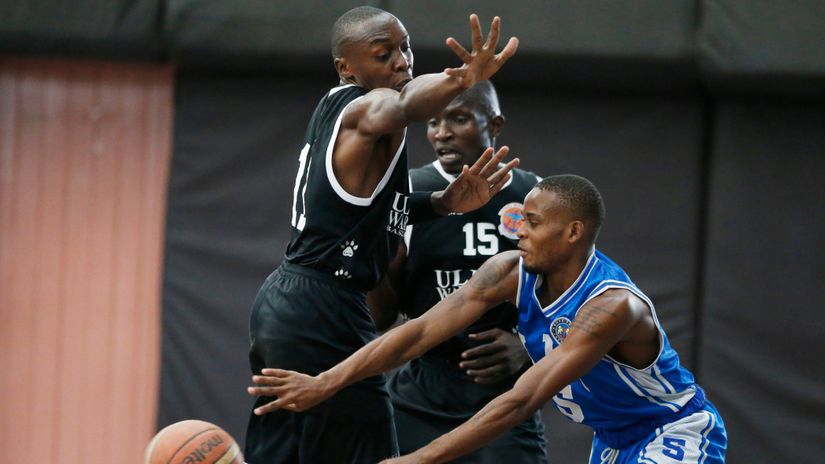 Eric Mutoro and Byron Mabonga attempt to block Lennox Wanje 