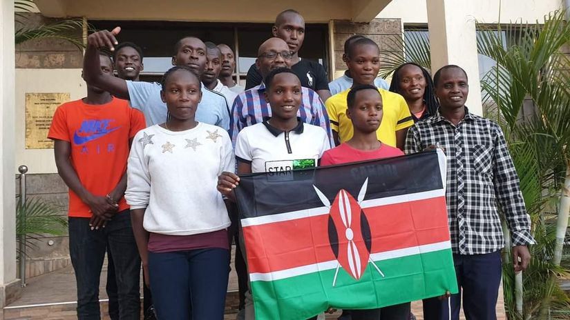 Winny Chepng’etich (L in white) poses for a photo ahead of a trip to France 