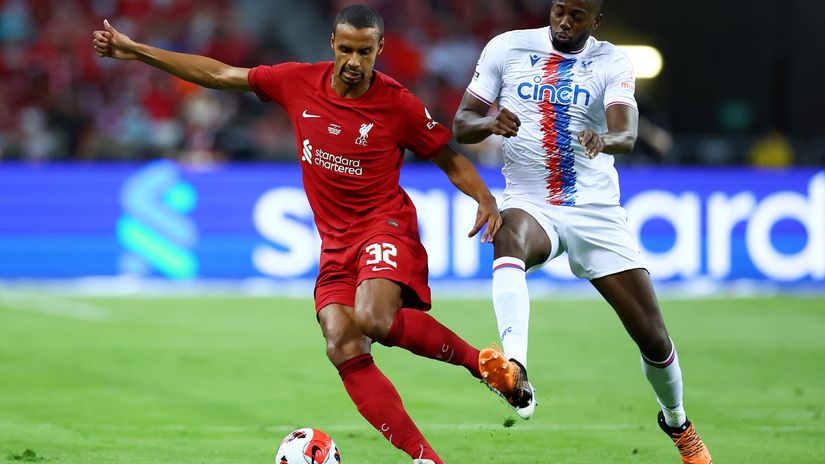 Matip runs away with the ball from Jean-Philippe Mateta (©Yong Teck Lim/Getty Images)