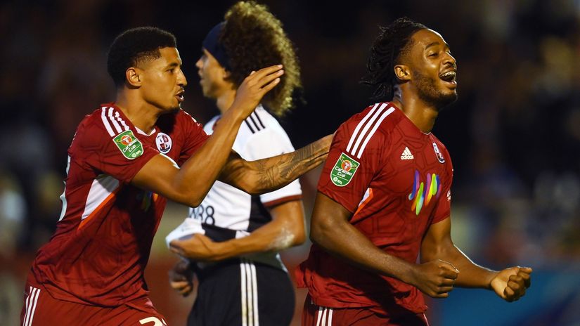 James Balagizi of Crawley Town celebrates with teammate after scoring against Fulham (©Mike Hewitt/Getty Images)