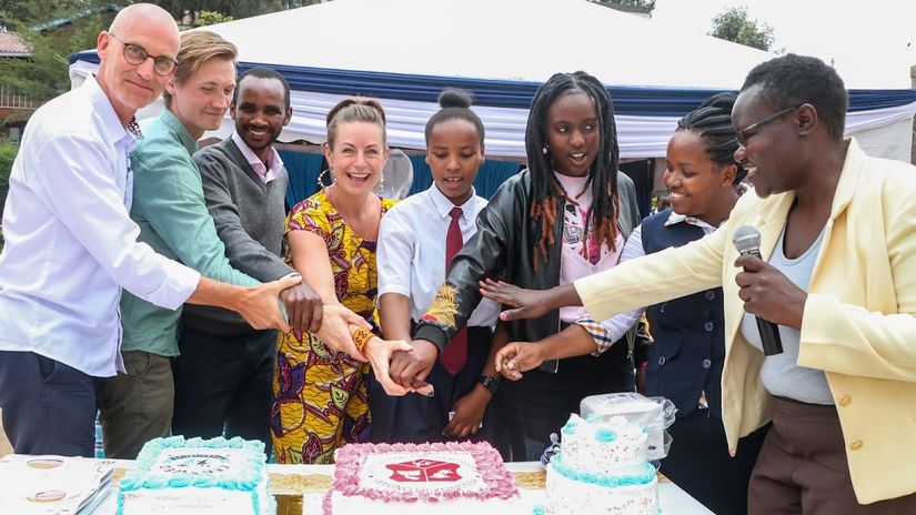 Isaac Macharia (3rd R) joins partners in cutting a cake to commemorate Kenswed Organisation's 10th anniversary © Courtesy 