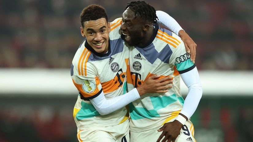 Jamal Musiala and Alphonso Davies celebrate (©Alexander Hassenstein/Getty Images)