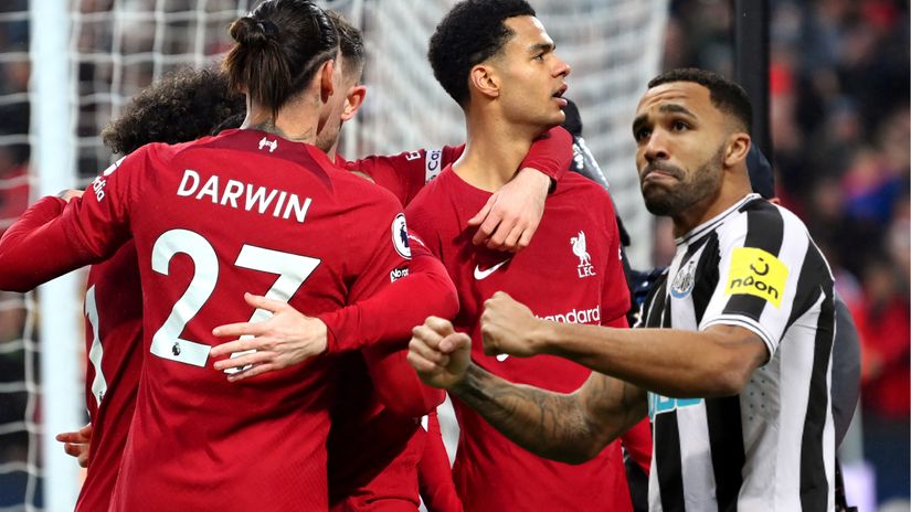 Liverpool players celebrating on the left, while Wilson reacts on the right (©Getty images sport)