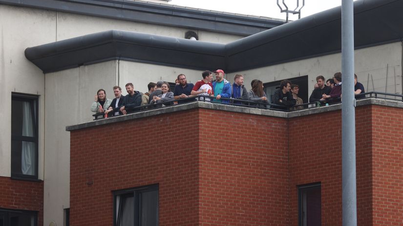 Leyton Orient fans gather to watch a game from a penthouse flat overlooking the ground (©Pete Norton/Getty Images)