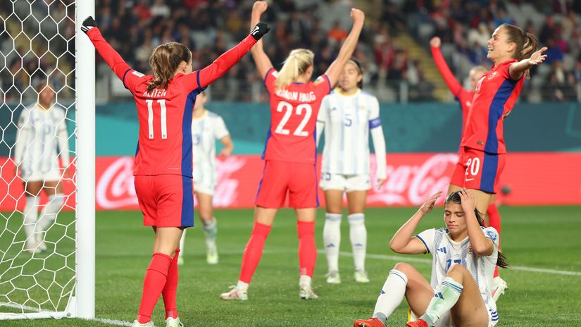 Alicia Barker of Philippines looks dejected after scoring an own goal, while the rivals celebrate (©Phil Walter/Getty Images)