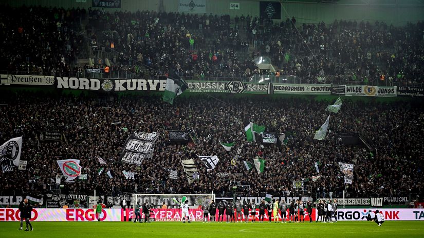Players of Borussia Monchengladbach celebrate with their fans following the team's victory in the German Cup (©Frederic Scheidemann/Getty Images)