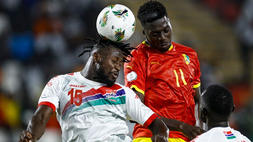  Gambia's full-back #15 Jacob Mendy fights for the ball with Guinea's midfielder #11 Mohamed Bayo (©AFP)