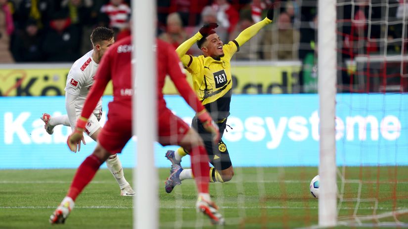 Sancho is challenged by Rasmus Carstensen of Koln resulting in a penalty (©Leon Kuegeler/Getty Images)