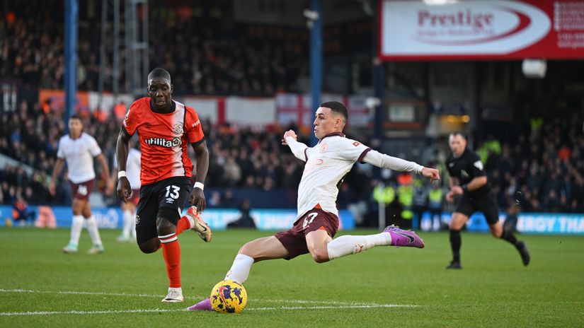 Foden of Manchester City in action against Nakamba of Luton Town at Kenilworth Road (©Shaun Botterill/Getty Images)