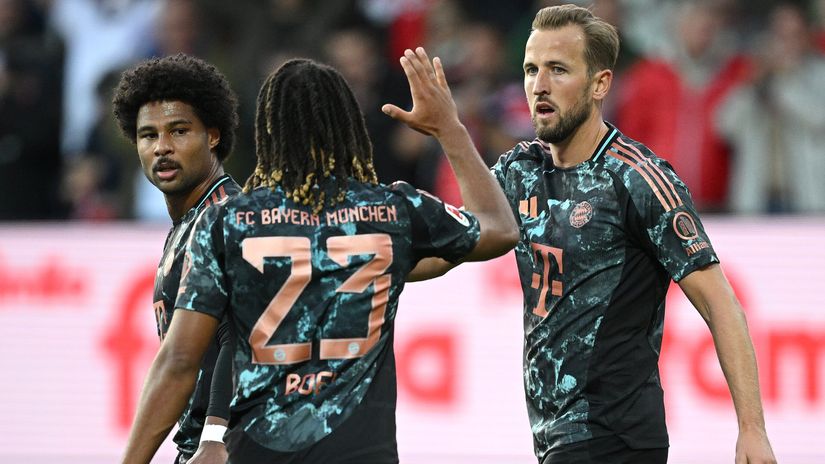 Kane celebrates after scoring with his teammates (©Stuart Franklin/Getty Images)