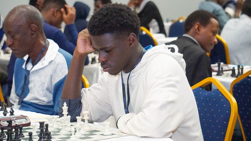 Caption (Kaloki Hawi in action at Kireka Open Chess Championships in Uganda © courtesy