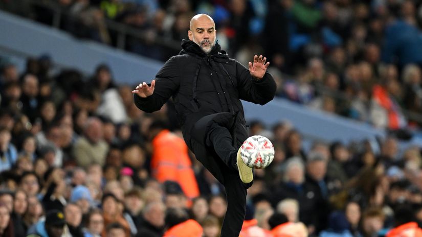 Pep Guardiola kicking the FA Cup ball (©Michael Regan/Getty Images)