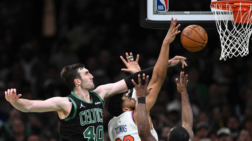 Luke Kornet #40 of the Boston Celtics blocks a shot by Karl-Anthony Towns #32 of the New York Knicks (©Brian Fluharty/Getty Images)