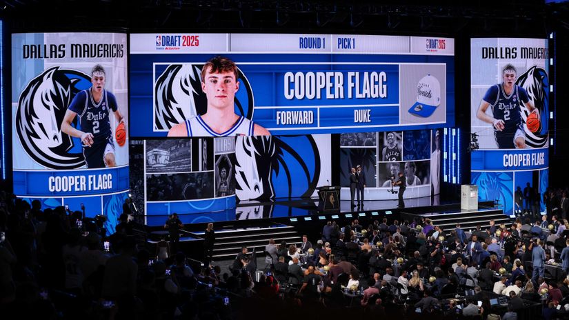 Cooper Flagg shakes hands with NBA commissioner Adam Silver after being drafted (©Mike Lawrie/Getty Images)