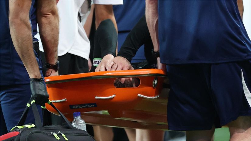 Maddison being taken off the pitch on a stretcher (©Chung Sung-Jun/Getty Images)