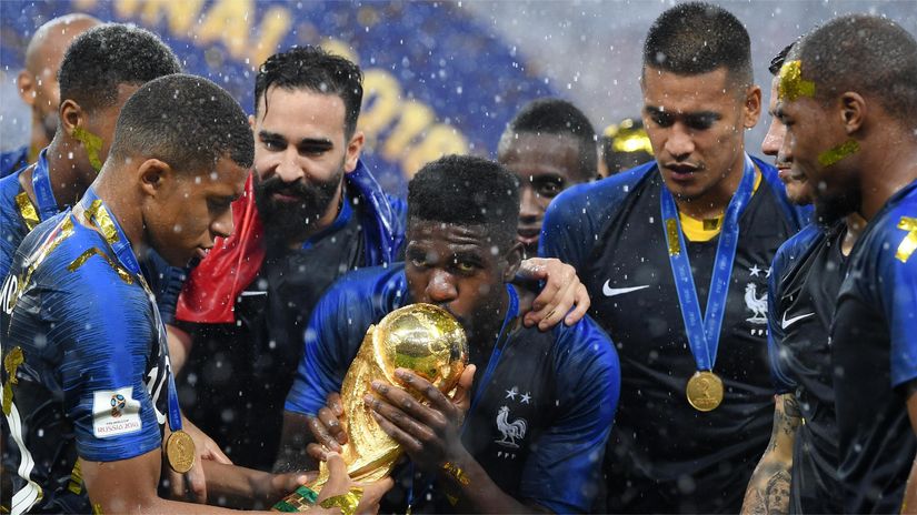 Umtiti kisses the World Cup trophy upon France's triumph in 2018 (©Matthias Hangst/Getty Images)