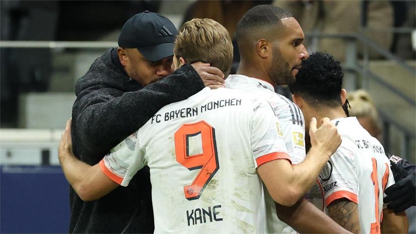 Kompany hugs Kane with Tah next to them (©Alexander Hassenstein/Getty Images)