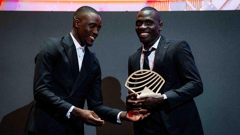 Emmanuel Wanyonyi receives his trophy from Letsile Tebogo at the World Athletics Awards 2025 (© World Athletics photographer icon Chiara Montesano)