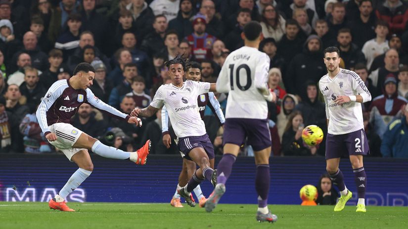 Rogers scores his first goal surrounded by United players (©Alex Pantling/Getty Images)