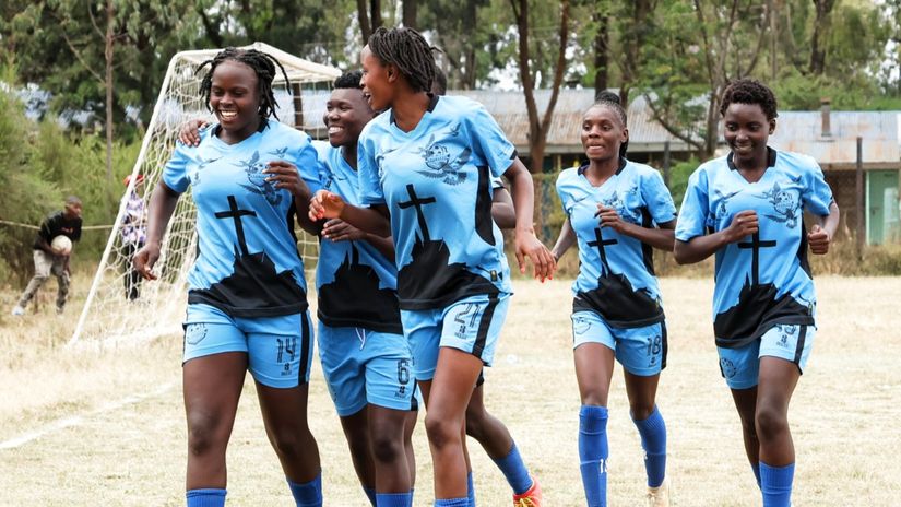 Trinity players celebrating Centrine Ngasi's goal © Gad Isaac