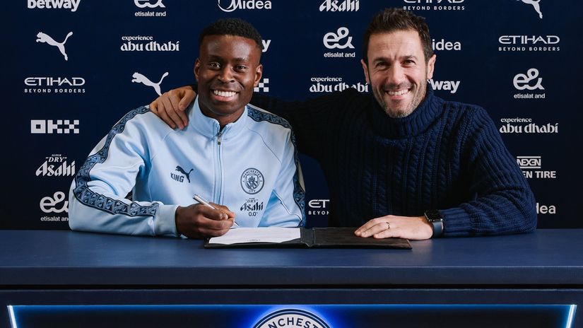 Guehi at the contract signing with Man City's sporting director Hugo Viana (©x.com/ManCity)
