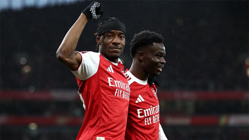 Madueke and Saka celebrate the opener (©James Fearn/Getty Images)