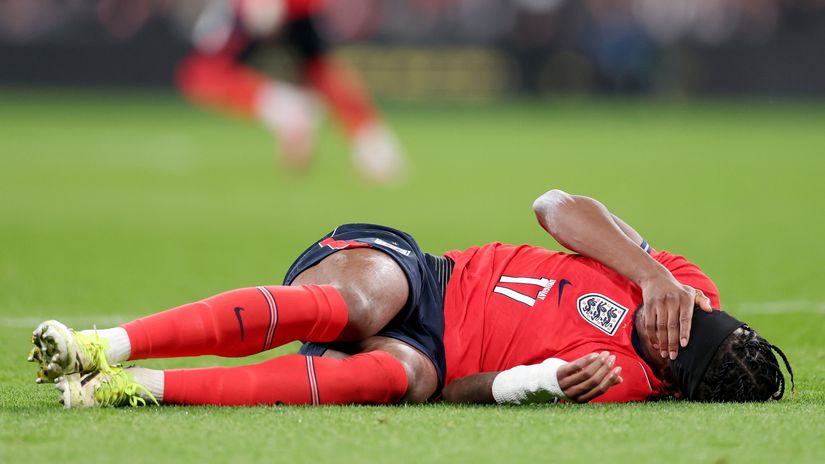 Madueke on the ground in pain after suffering the injury last night (©Julian Finney/Getty Images)