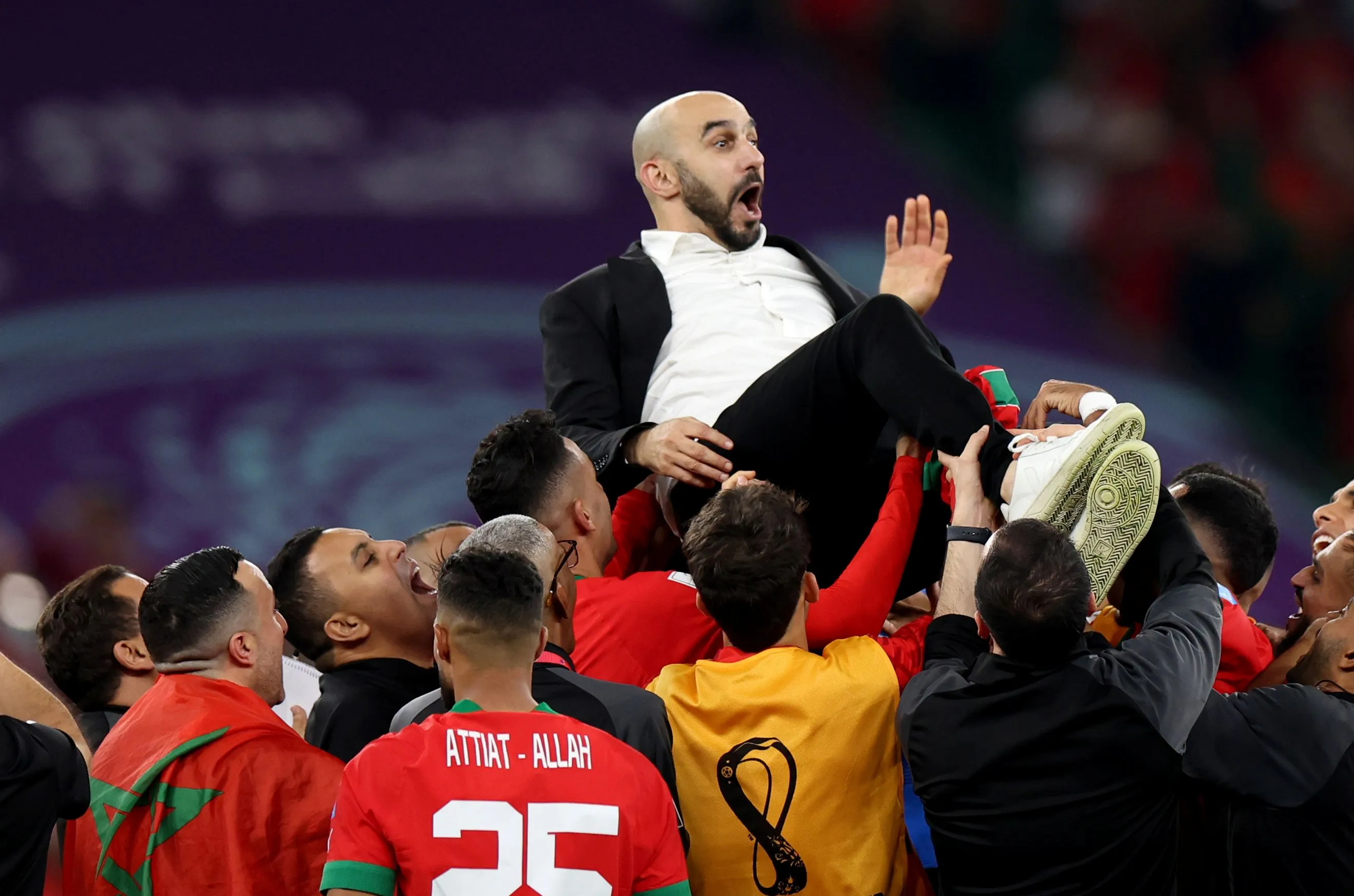 Regragui celebrating Morocco's place in the 2022 World Cup semi-finals with his players (©Francois Nel/Getty Images)