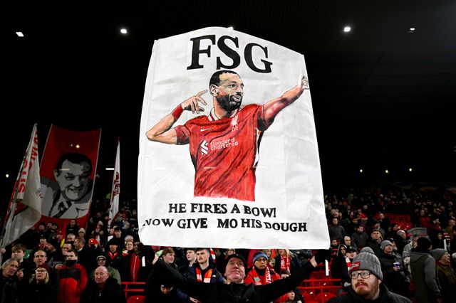 Liverpool fans with the "Give Mo his dough" banner Carragher mentioned (©Justin Setterfield/Getty Images)