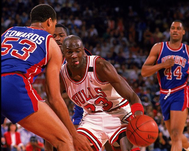 Michael Jordan in action surrounded by the Pistons, back in 1988 (©Allsport /Allsport/Getty Images)