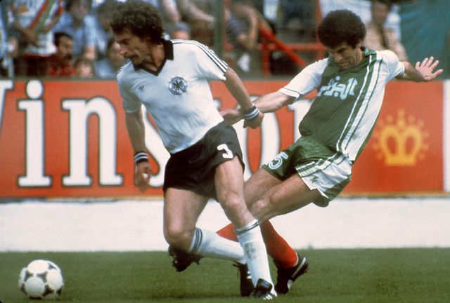 Paul Breitner of West Germany and Mustapha Dahleb of Algeria in action at the 1982 World Cup (©AFP)